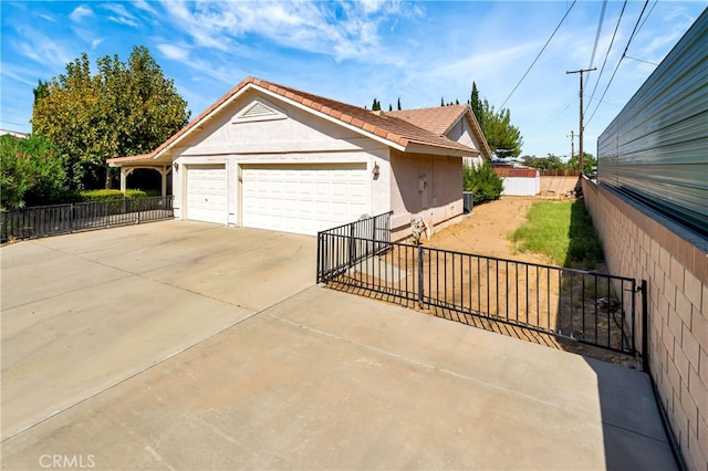 view of side of property featuring a garage and an outbuilding