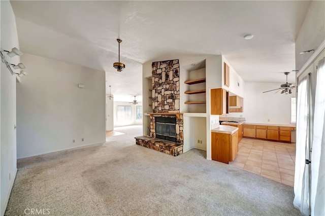 unfurnished living room featuring a fireplace and light colored carpet