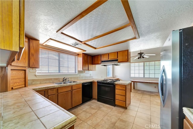 kitchen with ceiling fan, sink, kitchen peninsula, black appliances, and a textured ceiling