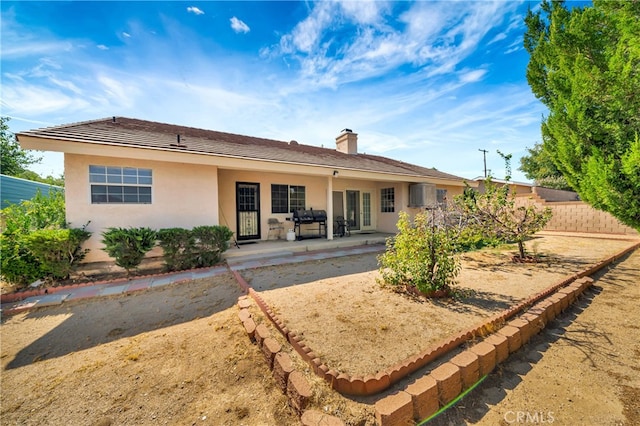 back of property with a patio