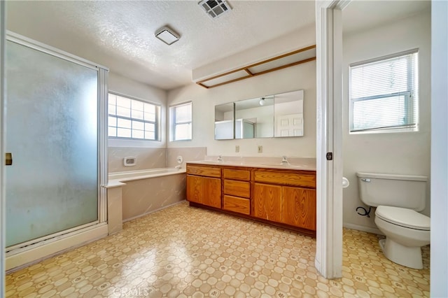 full bathroom with independent shower and bath, vanity, toilet, and a textured ceiling