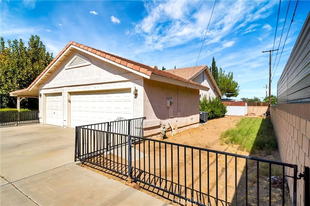 view of front of property with cooling unit and a garage