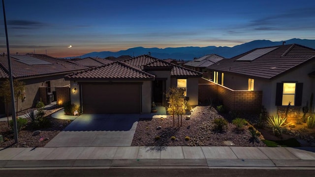 view of front of house featuring a mountain view and a garage