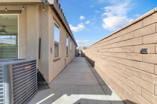 view of home's exterior with a patio area and central air condition unit