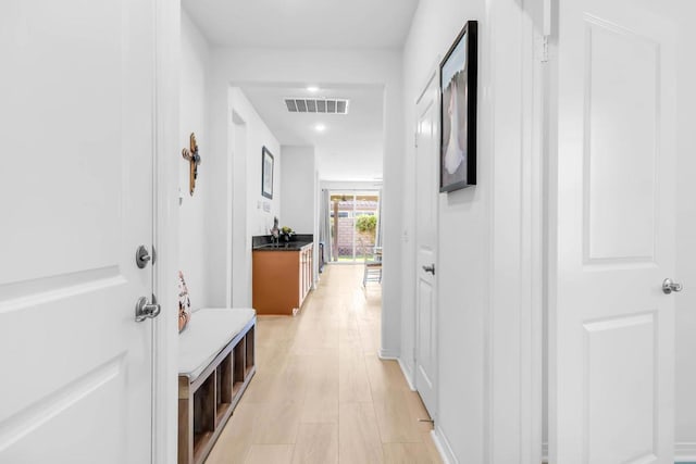 corridor with light hardwood / wood-style flooring