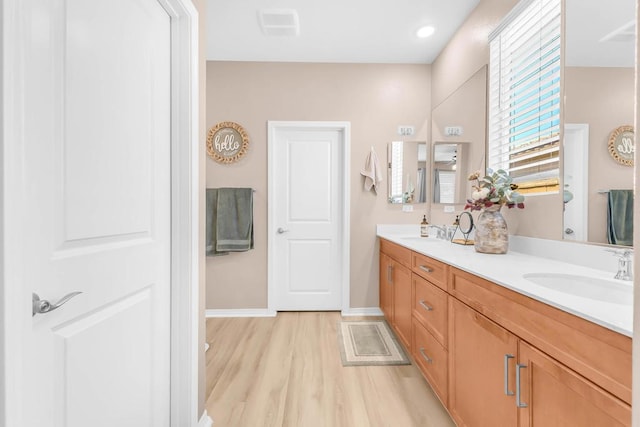 bathroom featuring vanity and hardwood / wood-style flooring