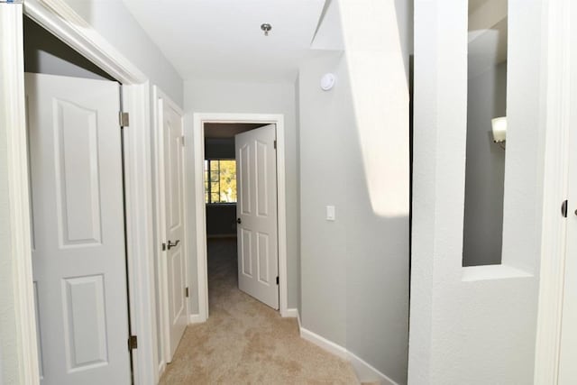 hallway with light colored carpet