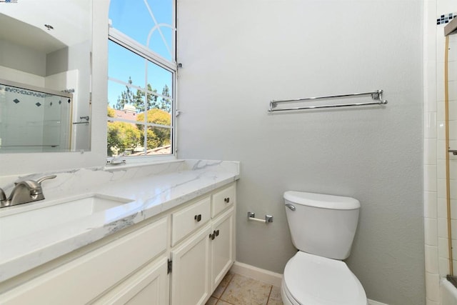 bathroom with tile patterned floors, vanity, an enclosed shower, and toilet