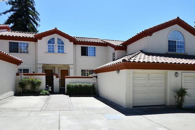 mediterranean / spanish house featuring a garage