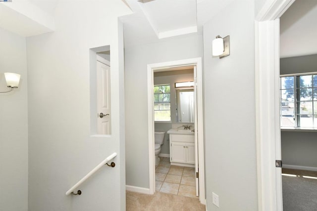 corridor with light colored carpet