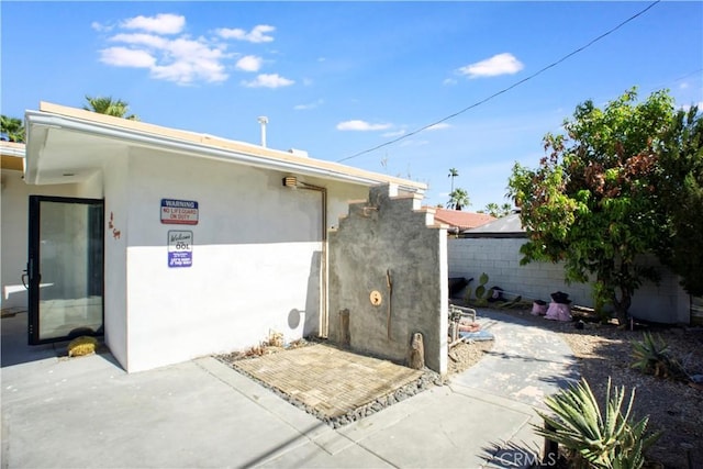 view of property exterior with a patio