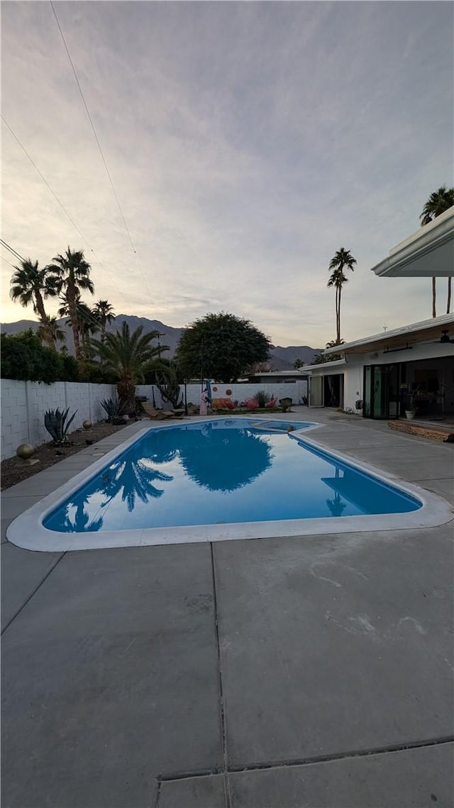 view of pool at dusk