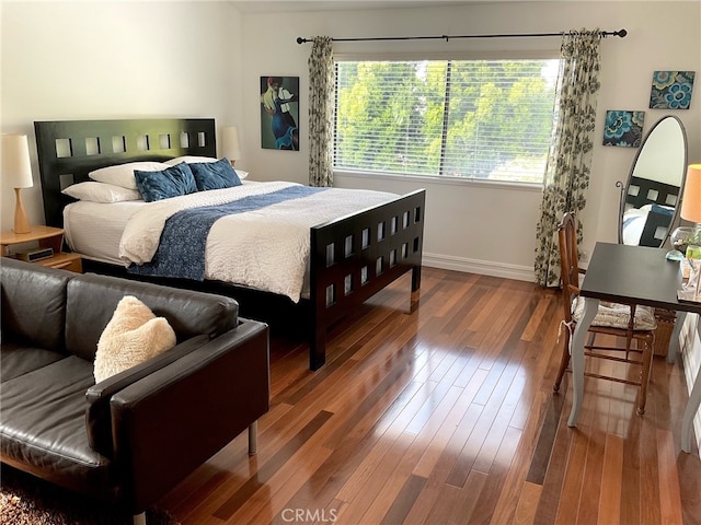 bedroom with dark wood-type flooring