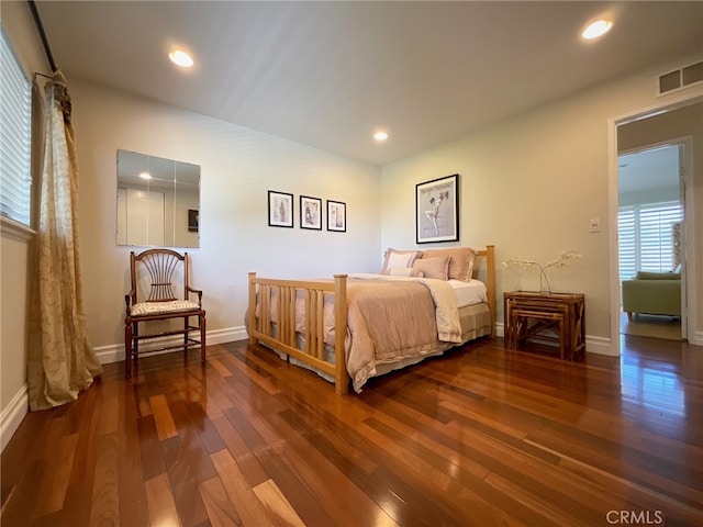 bedroom with dark hardwood / wood-style floors