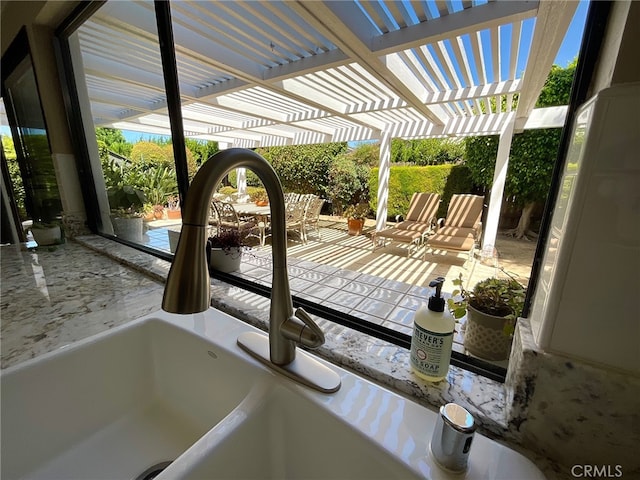 view of patio with a pergola and sink