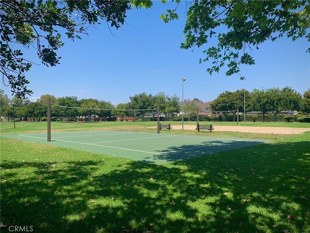 exterior space featuring a lawn and volleyball court