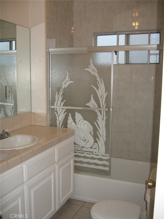 full bathroom with vanity, tile patterned floors, toilet, and combined bath / shower with glass door