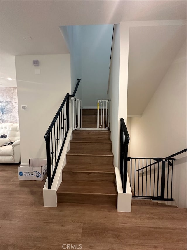 staircase with wood-type flooring