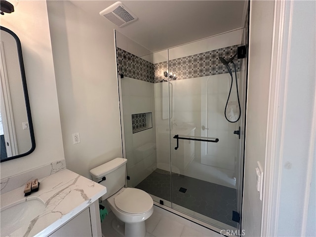 bathroom featuring a shower with door, tile patterned floors, vanity, and toilet