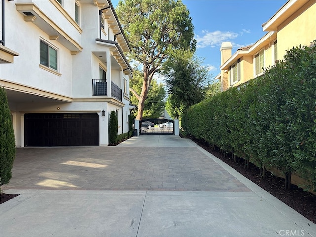 view of property exterior featuring a garage and a balcony