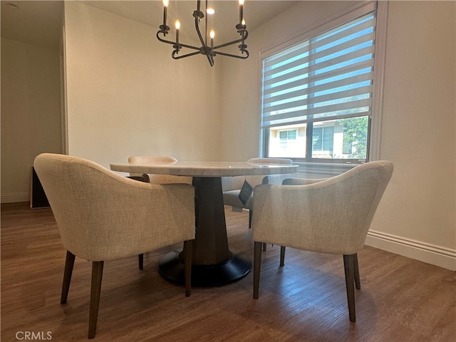 dining room with an inviting chandelier and wood-type flooring