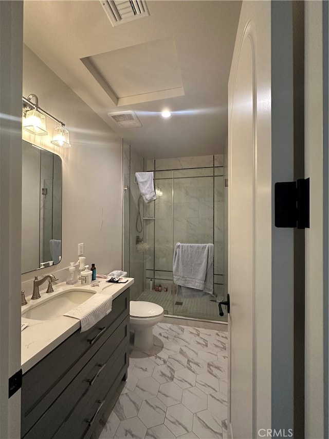 bathroom with vanity, toilet, and an enclosed shower