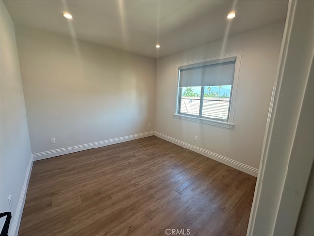 spare room featuring dark hardwood / wood-style flooring