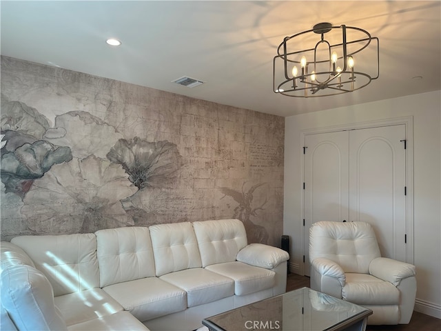 living room with hardwood / wood-style flooring and a notable chandelier