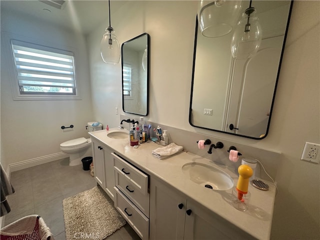 bathroom with tile patterned flooring, vanity, and toilet