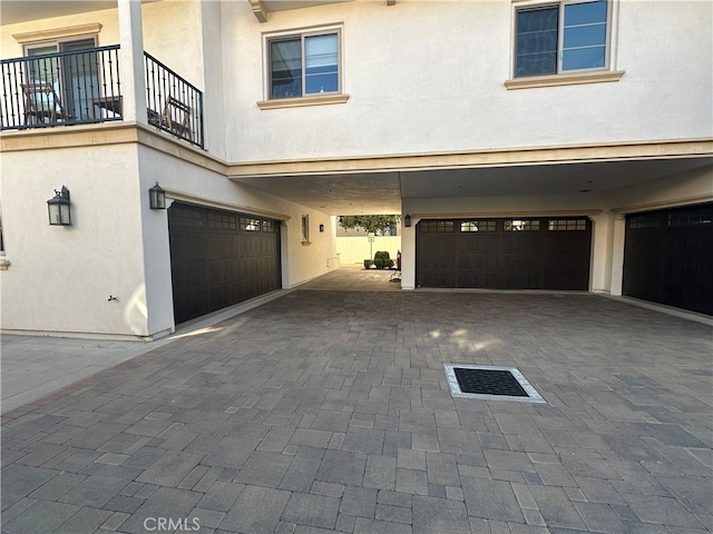 exterior space featuring a balcony and a garage