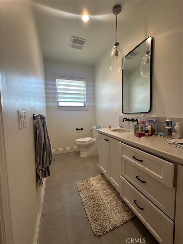 bathroom featuring tile patterned flooring, vanity, and toilet