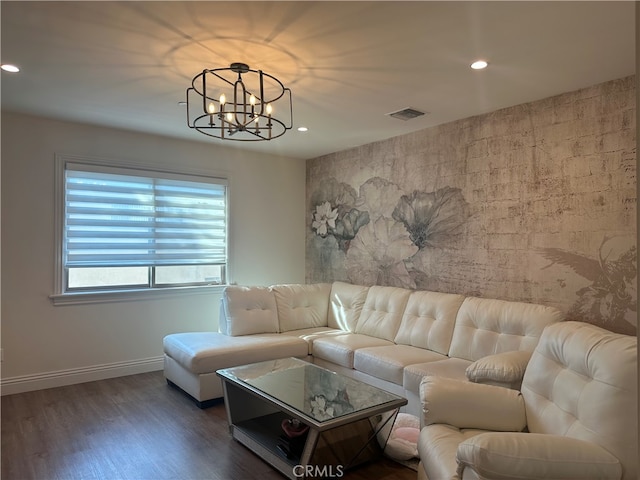 living room featuring an inviting chandelier and dark hardwood / wood-style floors