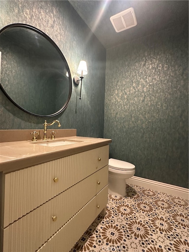 bathroom featuring vanity, toilet, and tile patterned floors