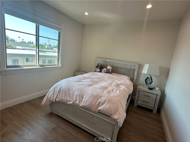 bedroom with dark wood-type flooring