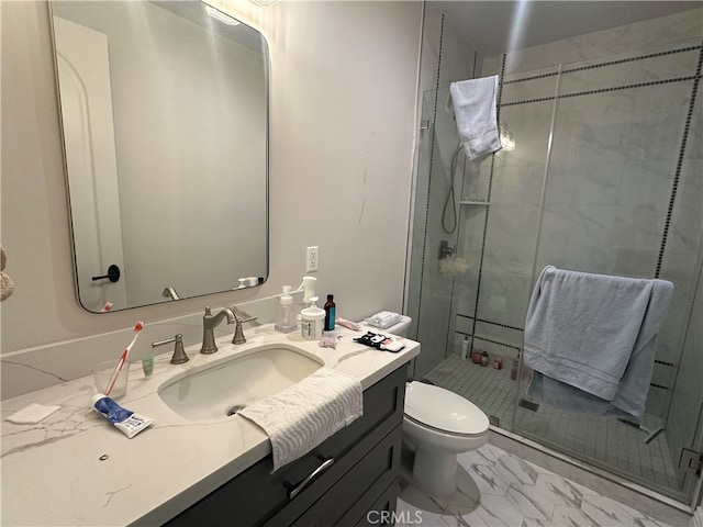 bathroom with an enclosed shower, vanity, and toilet