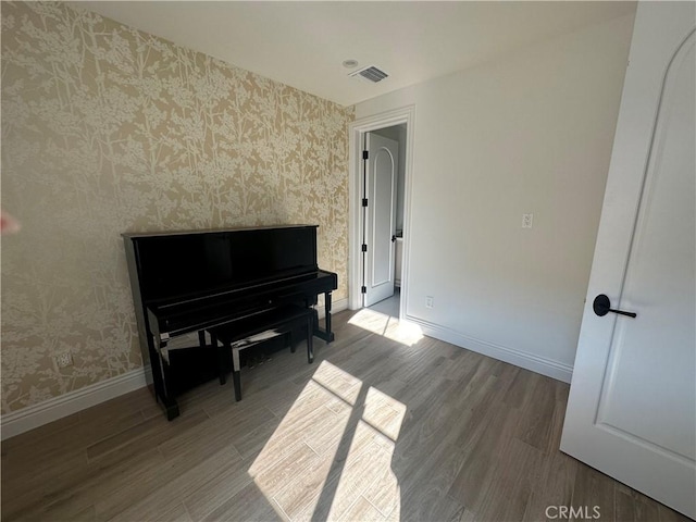 418UNITD W Fairview Ave Unit D, Arcadia, CA 91007 - living area with wallpapered walls, wood finished floors, and baseboards
