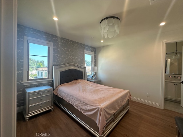 bedroom with billiards, connected bathroom, and dark wood-type flooring