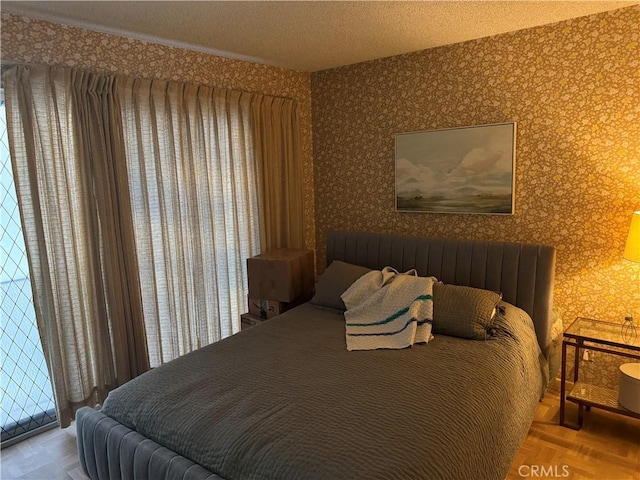 bedroom with parquet flooring and a textured ceiling