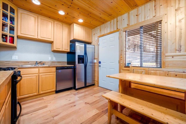 kitchen with light brown cabinetry, appliances with stainless steel finishes, light hardwood / wood-style floors, and wooden ceiling