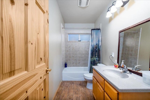 full bathroom with vanity, shower / bath combo, hardwood / wood-style flooring, and toilet