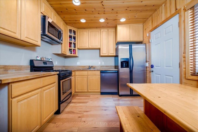 kitchen featuring appliances with stainless steel finishes, light brown cabinets, wooden ceiling, and light hardwood / wood-style floors