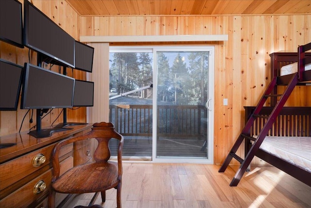 interior space featuring wooden walls, wooden ceiling, and light wood-type flooring