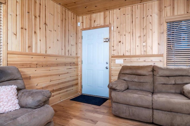 living room with wood ceiling, hardwood / wood-style flooring, and wood walls