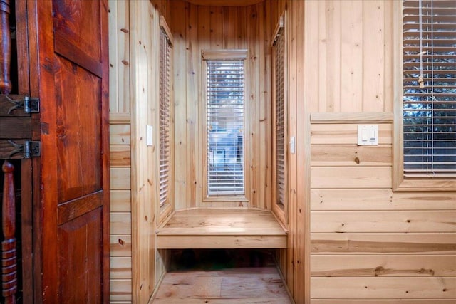 mudroom featuring wood walls