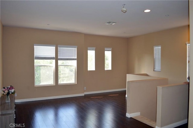 spare room featuring dark wood-type flooring