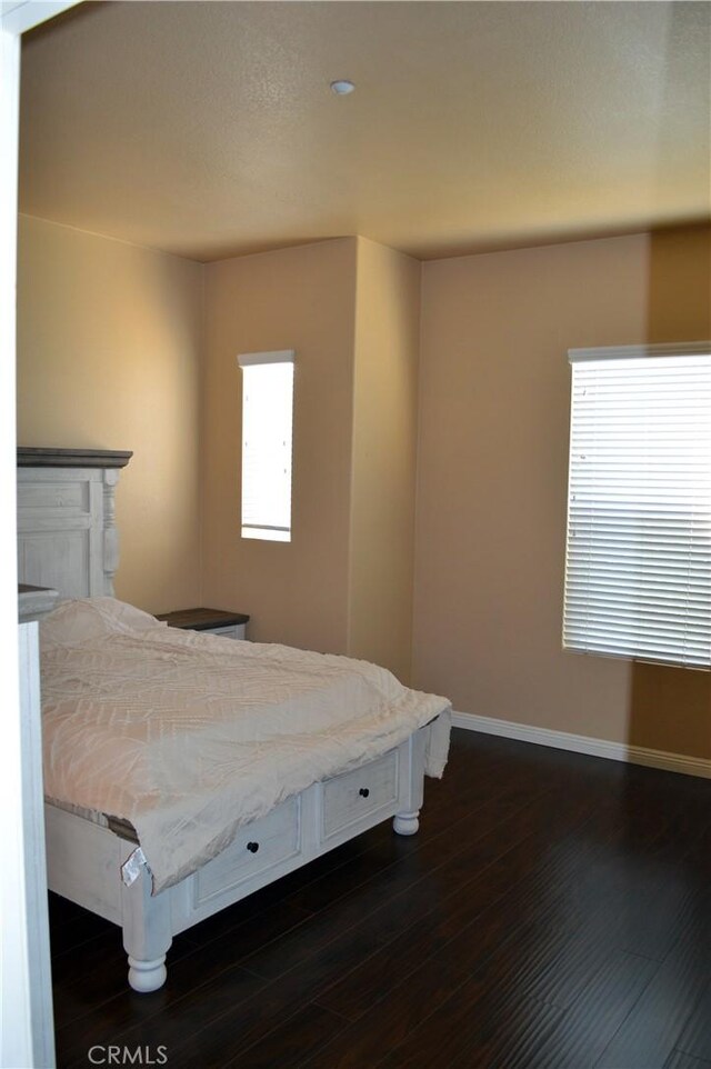 bedroom featuring dark hardwood / wood-style flooring