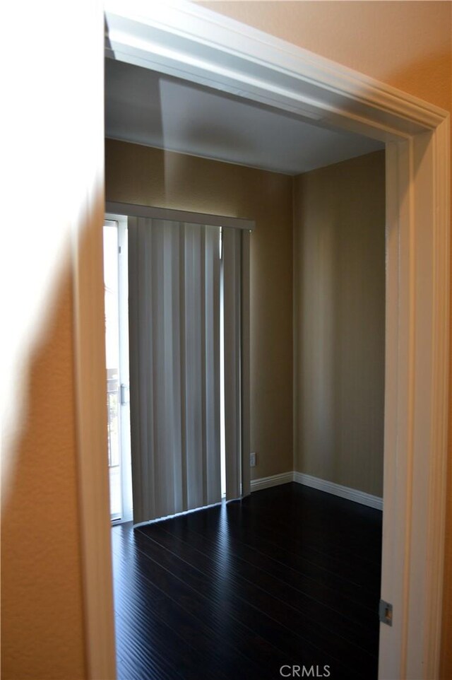 unfurnished room with dark hardwood / wood-style floors