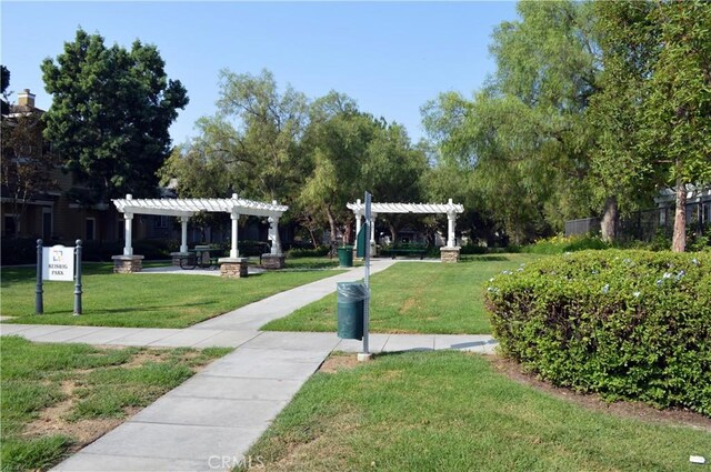 surrounding community with a pergola and a lawn