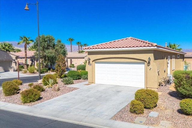 mediterranean / spanish-style house with a garage