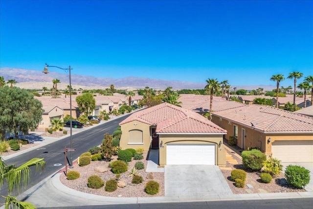 view of front of property featuring a mountain view and a garage